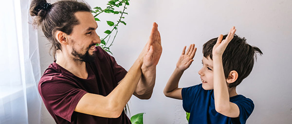 adult and child giving double high-fives