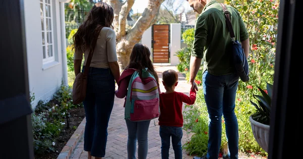 family leaving their home on a sunny day