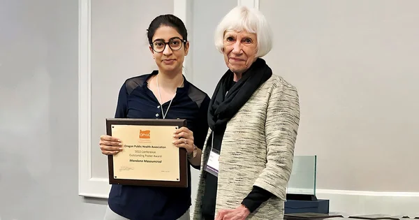Marie Harvey presenting award to Mandana Masoumirad
