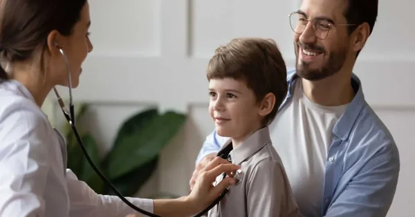 father and child talking with doctor