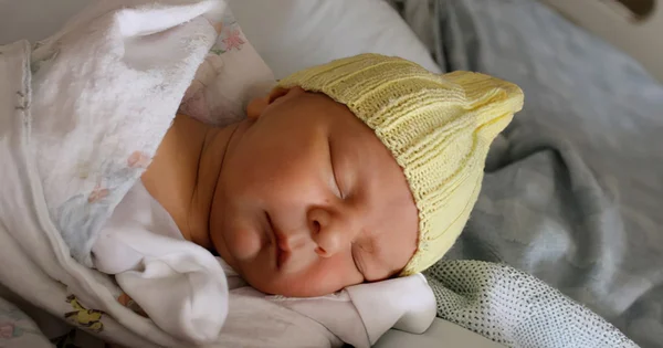 A peaceful image of a baby sleeping, representing the beginning of life, new beginnings, or newborn health.