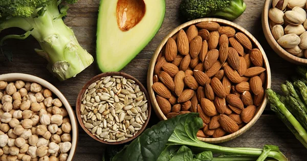 An assortment of healthy, whole foods known for their Vitamin E content, representing a balanced and nutritious diet for health and disease prevention.