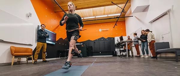 student researcher running in lab with motion capture