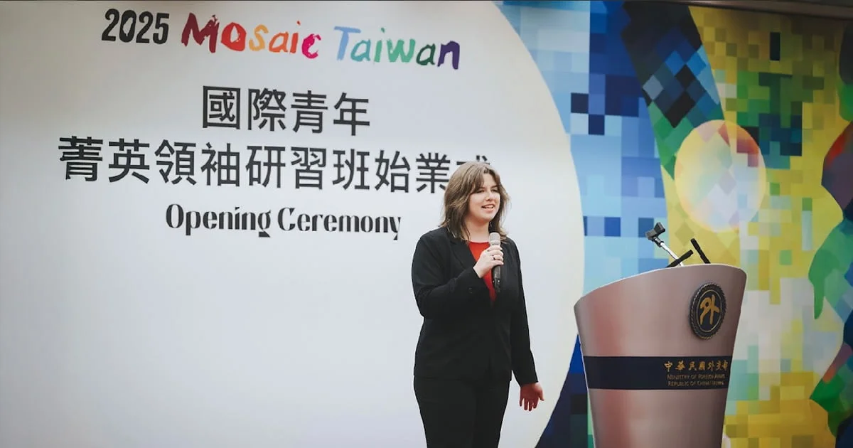 Izabel Kickner speaking at a podium during an opening ceremony for a Mosaic Taiwan 2025 event, with a colorful background and text in Chinese and English.