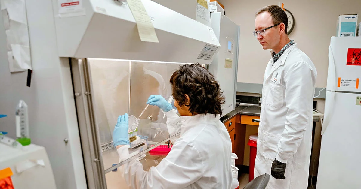 Scientists conduct an experiment in a sterile lab environment, highlighting the precision and collaborative nature of nutrition research.
