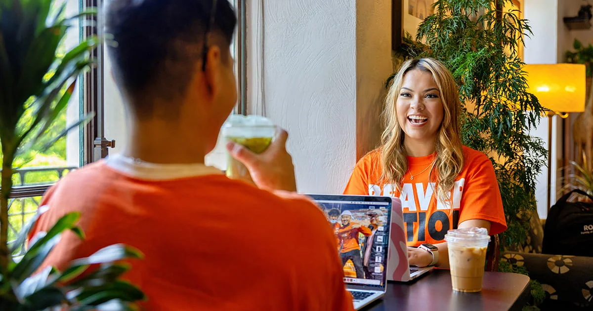 Students collaborating or studying together in a cafe, representing a positive and interactive learning environment at Oregon State, relevant to health and well-being.
