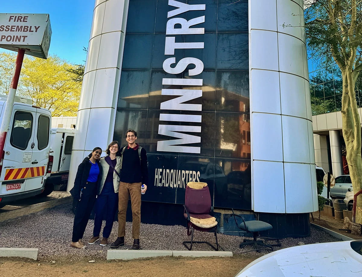 A group of students posing in front of a Ministry building, representing an international field experience or government-related study.