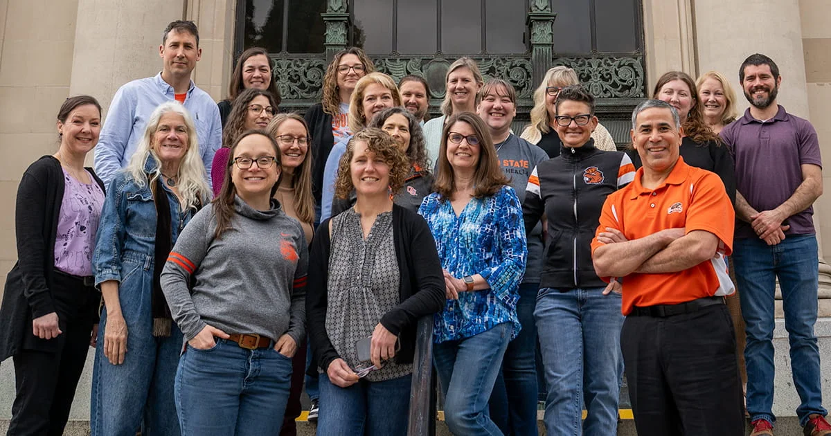Group portrait of HDFS department faculty and staff, with several members wearing orange and black Oregon State University apparel.