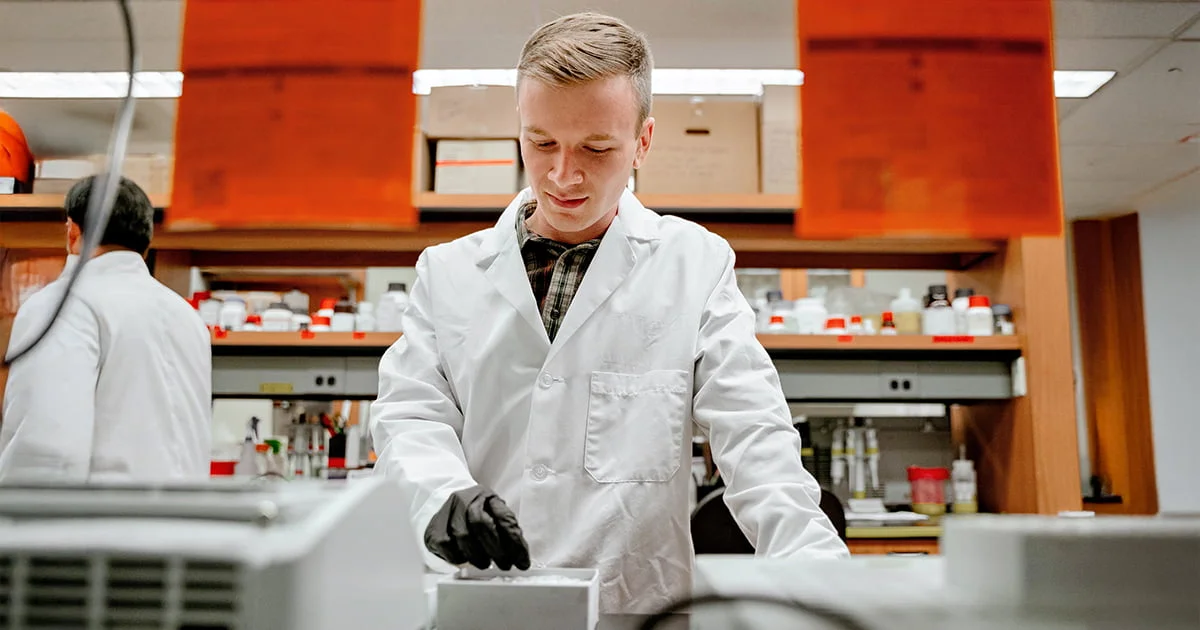A student conducting hands-on research in a nutrition science lab, illustrating practical learning experience.