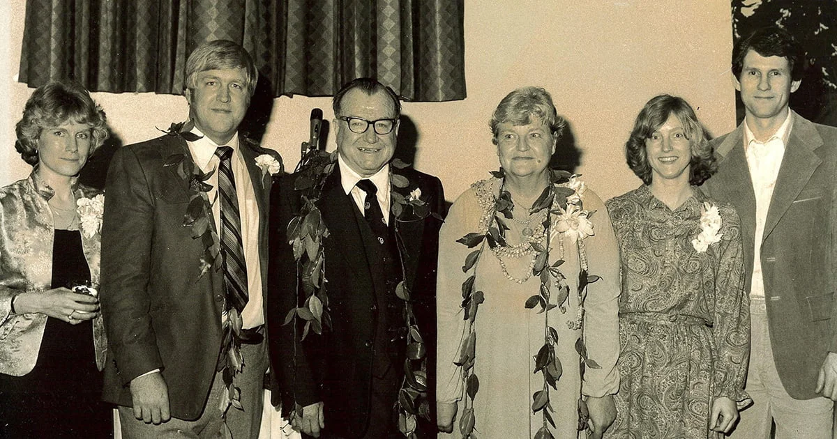 A formal group portrait of a family of six dressed up for an event in the 1970s