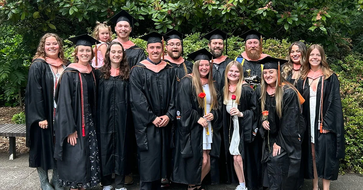 A celebratory group photo of Oregon State University graduates at a commencement event, showcasing student success and the completion of their academic programs.