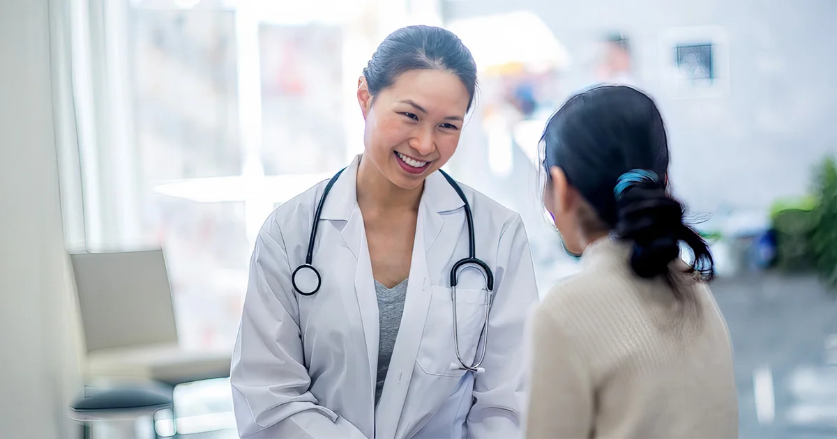 A physician delivers positive health news or provides compassionate care to a patient, symbolizing a successful medical consultation and positive outcomes.