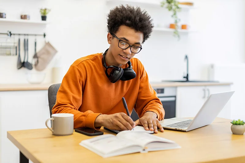 An online or distance learning student focuses on his coursework at home, emphasizing the flexibility of the Advanced Dietetics program.
