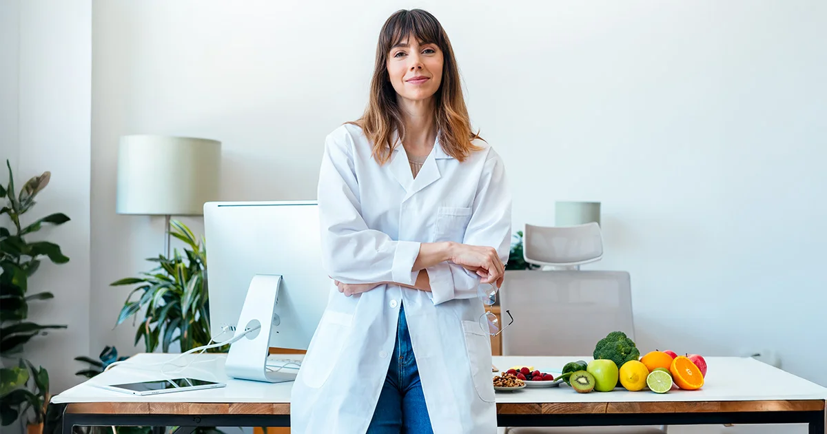 Professional portrait of a dietitian or graduate of an advanced nutrition program, signifying expertise in health and wellness consultation.