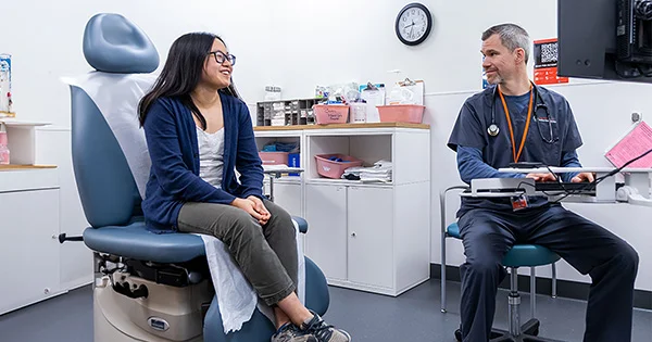 A student receiving a consultation at Student Health Services, illustrating the accessible, professional, and friendly healthcare support available to the university community.