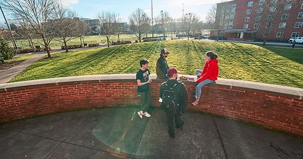Students gathered outside on the Oregon State University campus, illustrating the collaborative and community-focused nature of public health courses.