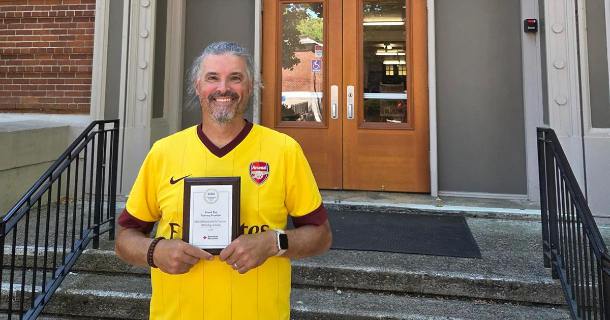 Casey Fries holding Red Cross Proud Top Training Provider Award