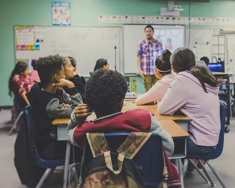 A diverse group of students in a classroom, illustrating a dynamic learning environment.
