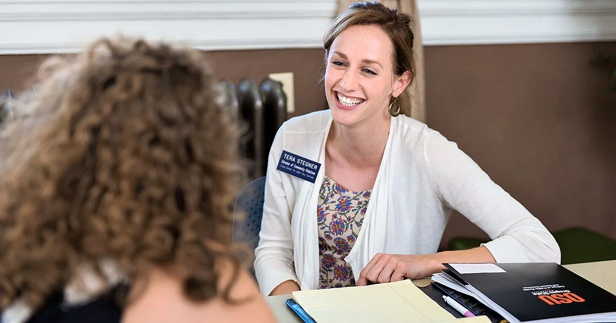 A student meets with an academic advisor, representing professional guidance and support services at the university.