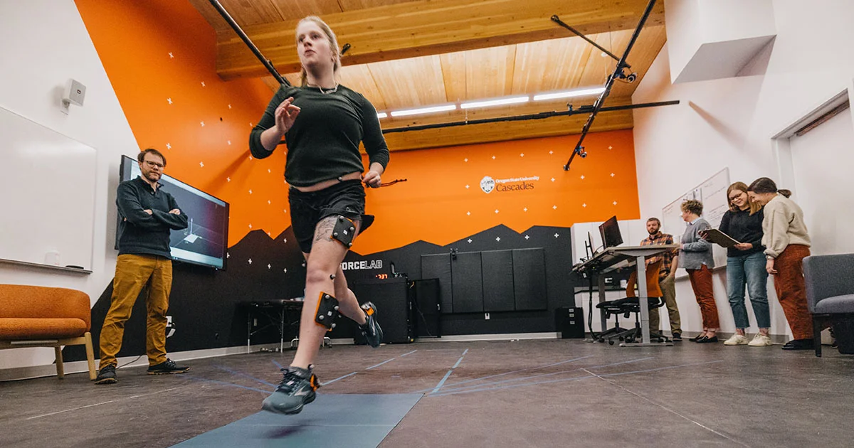 A student performs a biomechanics test in a lab, illustrating the hands-on research in kinesiology.