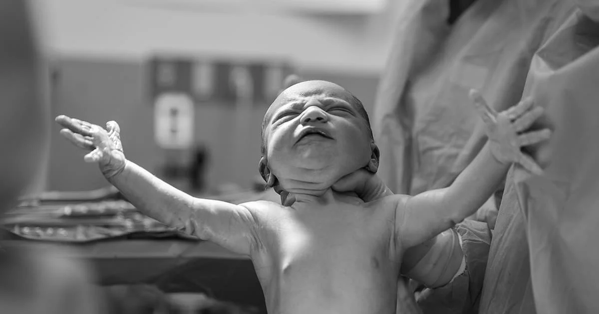 A powerful image of a newborn's first moments, illustrating the beginning of life and the vital role of maternal and neonatal healthcare services.