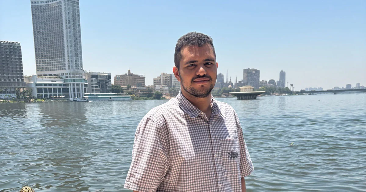 Mohamed Aboumengel stands in front of a river