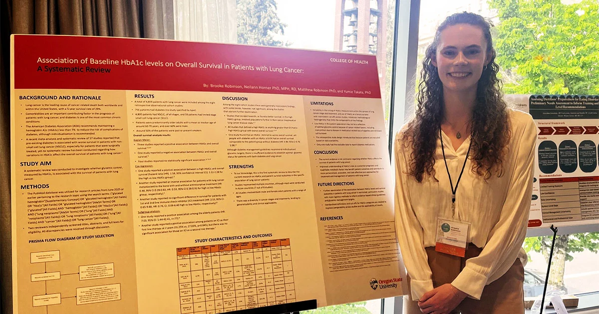 Brooke Robinson stands next to her research poster